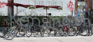 Bike rack made of a large bike chain spelling Kengsington
